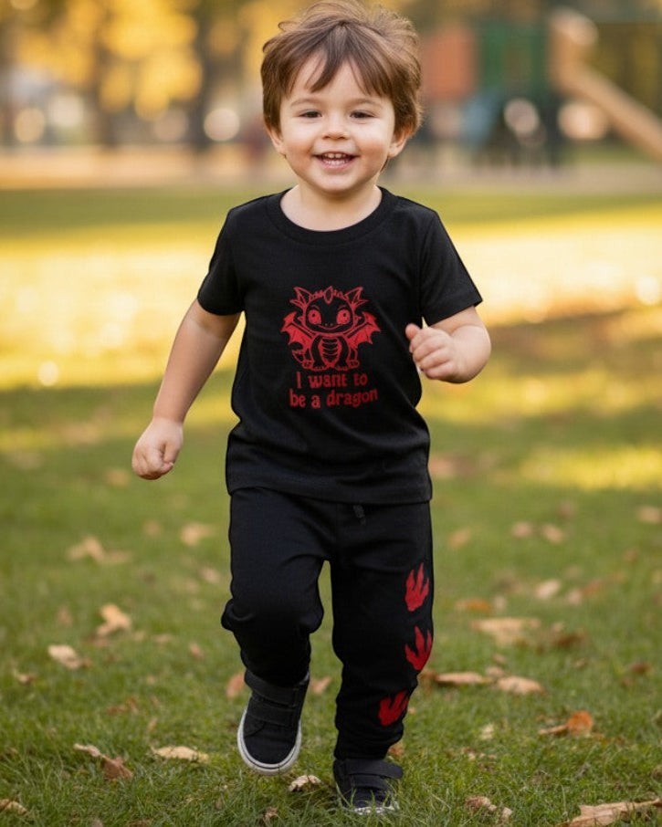 Toddler running in Calla Lily Cosmetics + CL kids black cotton-blend joggers with red dragon paw print design.