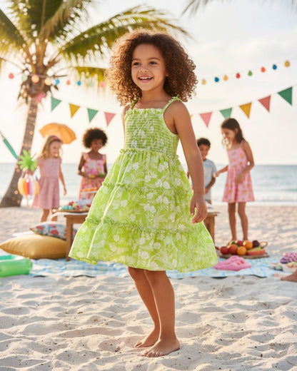 Girl wearing a Calla Lily Cosmetics + CL kids green floral rayon maxi dress with tiered layers and smocked bodice.