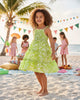 Girl wearing a Calla Lily Cosmetics + CL kids green floral rayon maxi dress with tiered layers and smocked bodice.