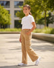 Girl wearing Calla Lily Cosmetics + CL kids Bonnie Bianca khaki cargo jeans with white stitching and side pockets