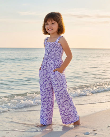 Girl wearing a light purple floral rayon romper by Calla Lily Cosmetics + CL kids on a beach at sunset.
