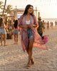 Woman wearing a roseclay mandala print kimono cardigan with tassels by Calla Lily Cosmetics + CL kids at a festival.