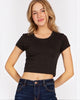 Model wearing a black Calla Lily Cosmetics + CL kids Rosio cropped baby t-shirt with a round neck and short sleeves.