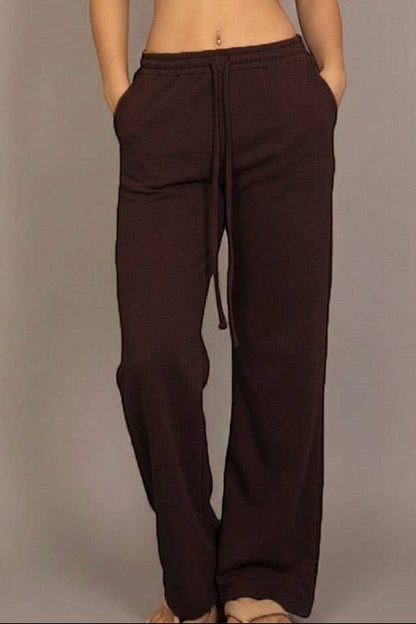 Calla Lily Cosmetics brown cotton French terry crop top with cap sleeves and elastic hem, paired with wide-leg pants.