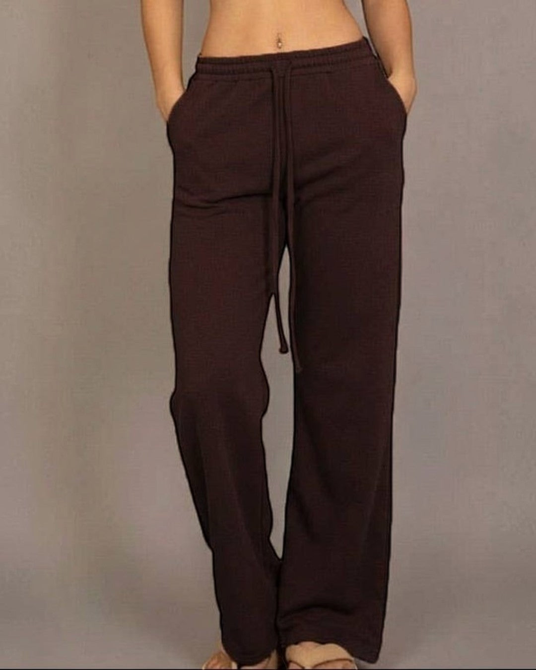 Calla Lily Cosmetics brown cotton French terry crop top with cap sleeves and elastic hem, paired with wide-leg pants.