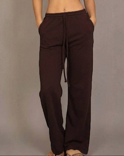Calla Lily Cosmetics brown cotton French terry crop top with cap sleeves and elastic hem, paired with wide-leg pants.