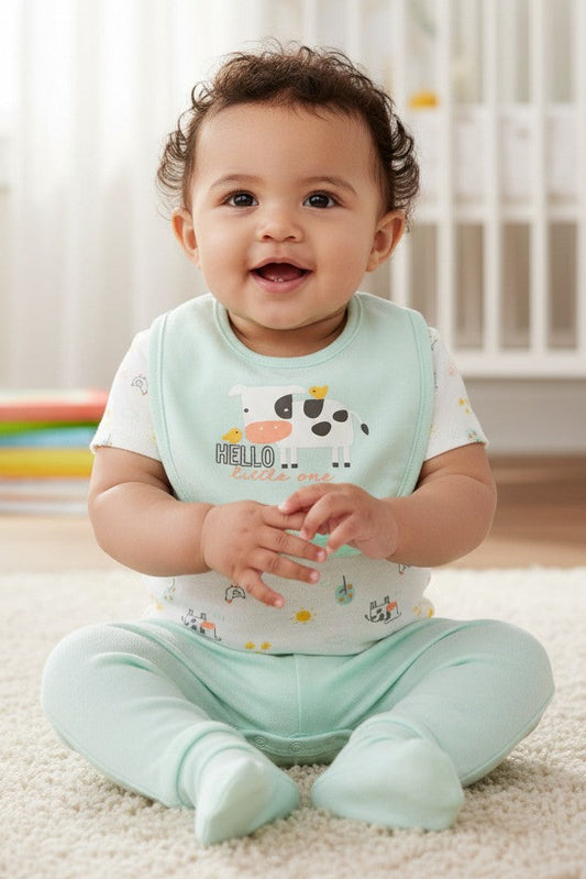 Calla Lily Cosmetics + CL kids 3pc baby set with white bodysuit featuring cow print, mint green pants, and a mint green bib with cow graphic.