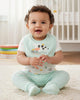Calla Lily Cosmetics + CL kids 3pc baby set with white bodysuit featuring cow print, mint green pants, and a mint green bib with cow graphic.