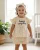 Calla Lily Cosmetics + CL kids cream cotton baby girl set with floral print top and ruffle shorts. "happy every day" text.