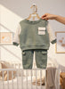 Calla Lily Cosmetics + CL kids sage green cotton blend jogger set with cream sleeves and pocket detail.