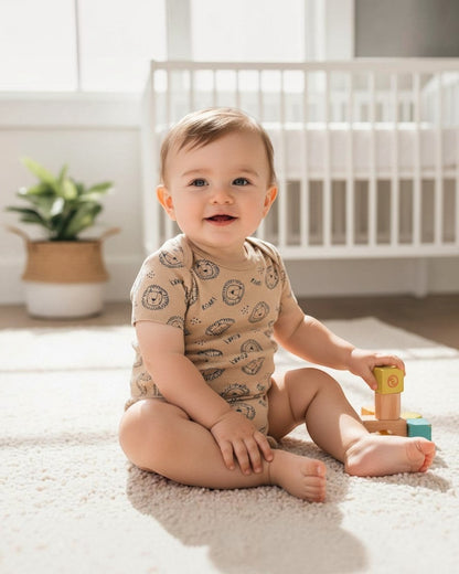 Calla Lily Cosmetics + CL kids tan 100% cotton baby bodysuit with all-over lion print and ROAR text.