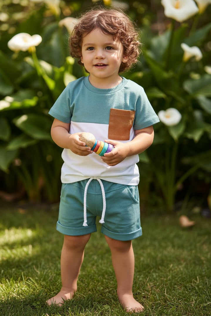 Calla Lily Cosmetics + CL kids blue and white colorblock t-shirt with brown pocket and matching shorts. Cotton-polyester blend.