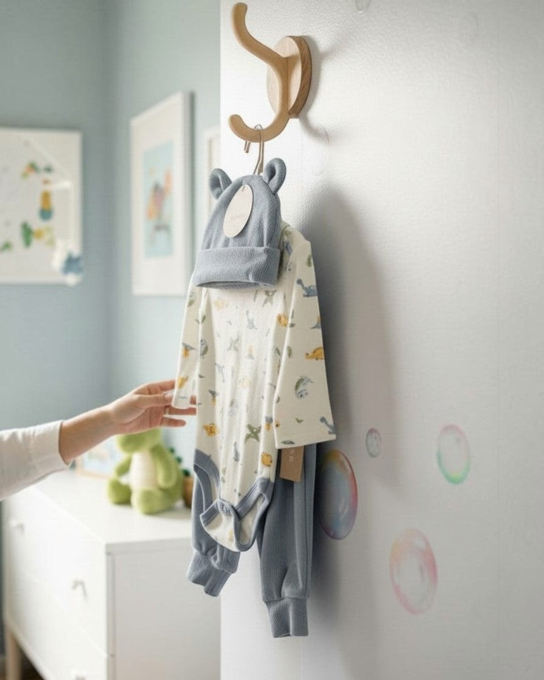 Calla Lily Cosmetics + CL kids blue 3-piece baby set with dinosaur print bodysuit, pants, and hat.
