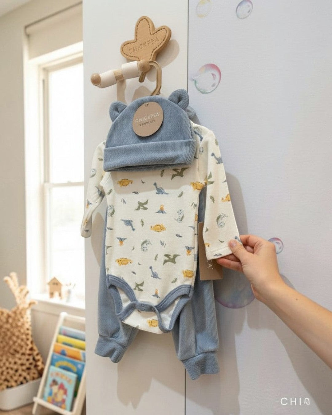 Calla Lily Cosmetics + CL kids blue ribbed knit 3-piece baby set with dinosaur print bodysuit and matching hat and pants.