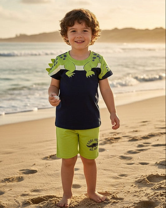 Calla Lily Cosmetics + CL kids blue cotton t-shirt with green dinosaur graphic and matching green shorts with "Cool Vibes All Day" print.