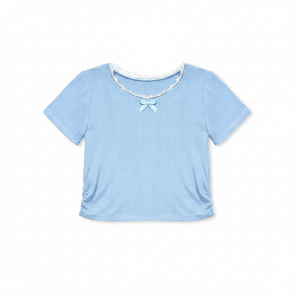 Calla Lily Cosmetics + CL kids light blue ribbed knit toddler t-shirt with lace trim and bow, paired with denim shorts.