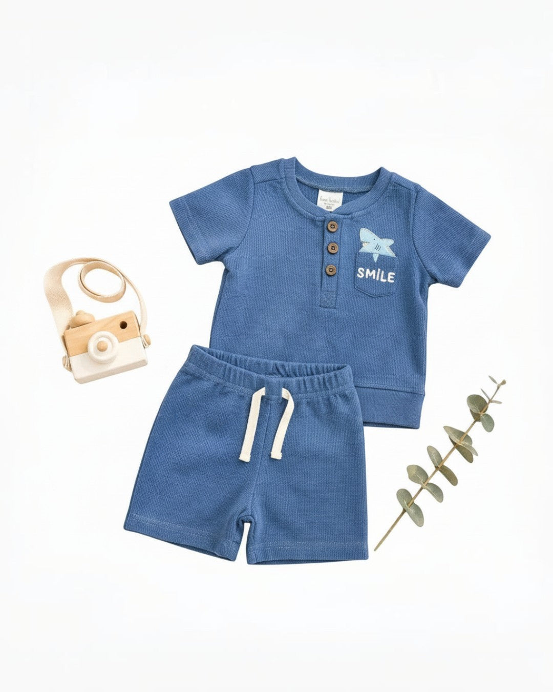 Calla Lily Cosmetics + CL kids blue waffle knit short sleeve top with shark embroidery and shorts set. Cotton-polyester blend.
