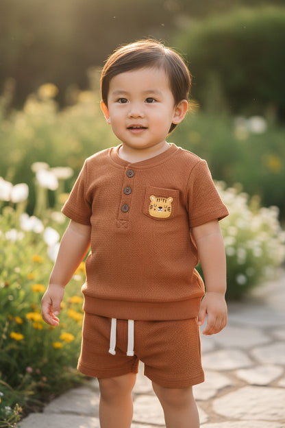 Calla Lily Cosmetics + CL kids brown waffle knit short sleeve top with button front and tiger patch, paired with matching shorts.