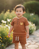 Calla Lily Cosmetics + CL kids brown waffle knit short sleeve top with button front and tiger patch, paired with matching shorts.