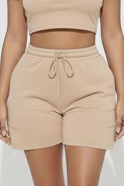 Calla Lily Cosmetics + CL kids cream cotton crop tee and drawstring shorts set on a model.