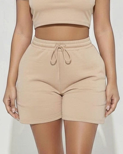 Calla Lily Cosmetics + CL kids cream cotton crop tee and drawstring shorts set on a model.