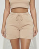 Calla Lily Cosmetics + CL kids cream cotton crop tee and drawstring shorts set on a model.
