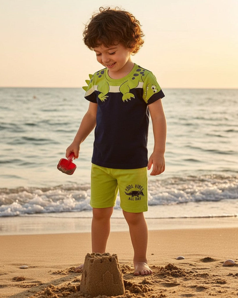 Calla Lily Cosmetics + CL kids blue cotton t-shirt with green dinosaur graphic and matching green shorts with "Cool Vibes All Day" print.