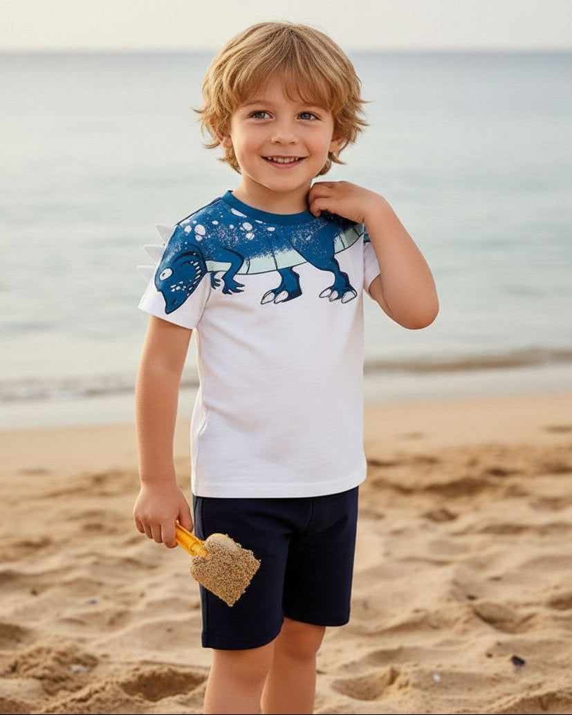Calla Lily Cosmetics + CL kids white cotton t-shirt with blue dinosaur graphic and navy shorts. Features 3D spikes on shoulders.