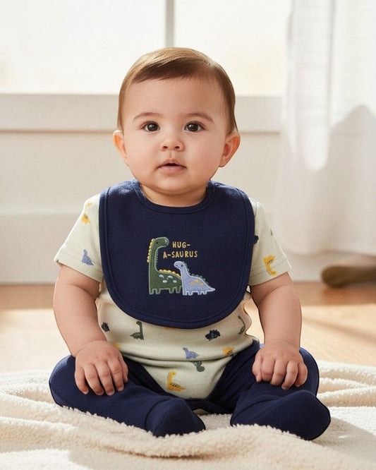 Calla Lily Cosmetics + CL kids 3-piece baby set with dinosaur print bodysuit, navy pants, and bib. 60% Cotton, 40% Polyester.