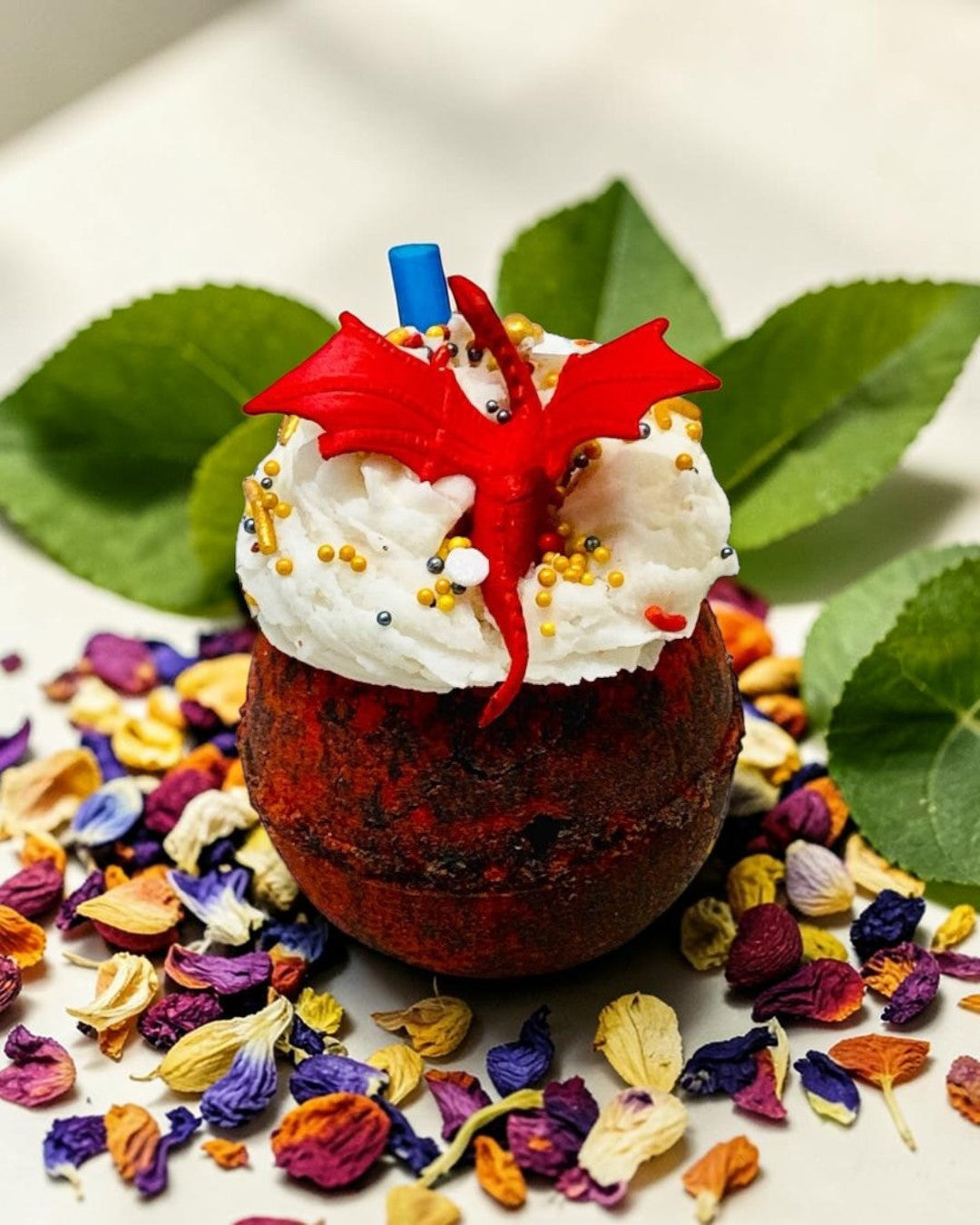 Calla Lily Cosmetics + CL kids dragon-themed 3-in-1 bubbly ball bath bomb with red dragon topper and gold sprinkles