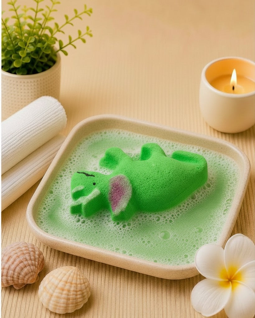 Calla Lily Cosmetics + CL kids green triceratops dinosaur bath bomb fizzing in a dish with citrus scent