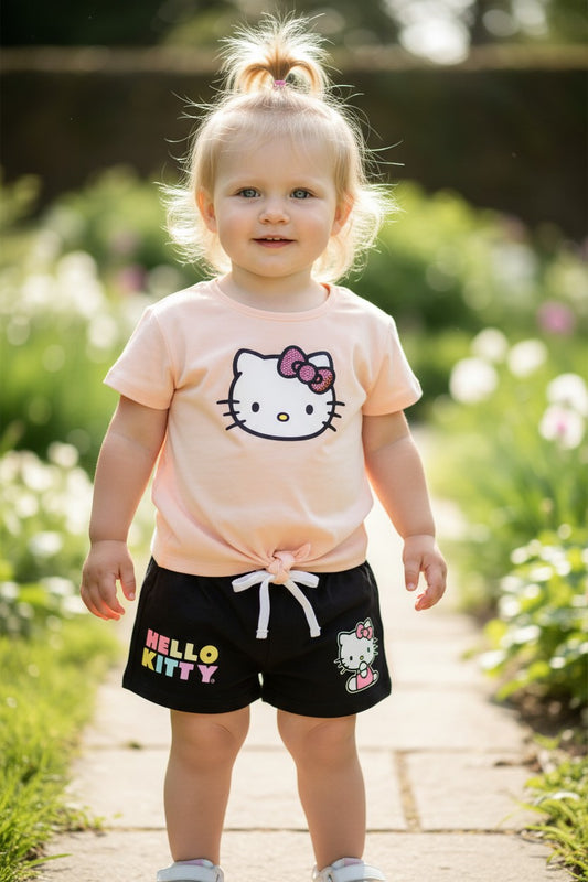 Calla Lily Cosmetics + CL kids Hello Kitty tan short set with tie-front top and black shorts with Hello Kitty graphic.