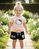 Calla Lily Cosmetics + CL kids Hello Kitty tan short set with tie-front top and black shorts with Hello Kitty graphic.