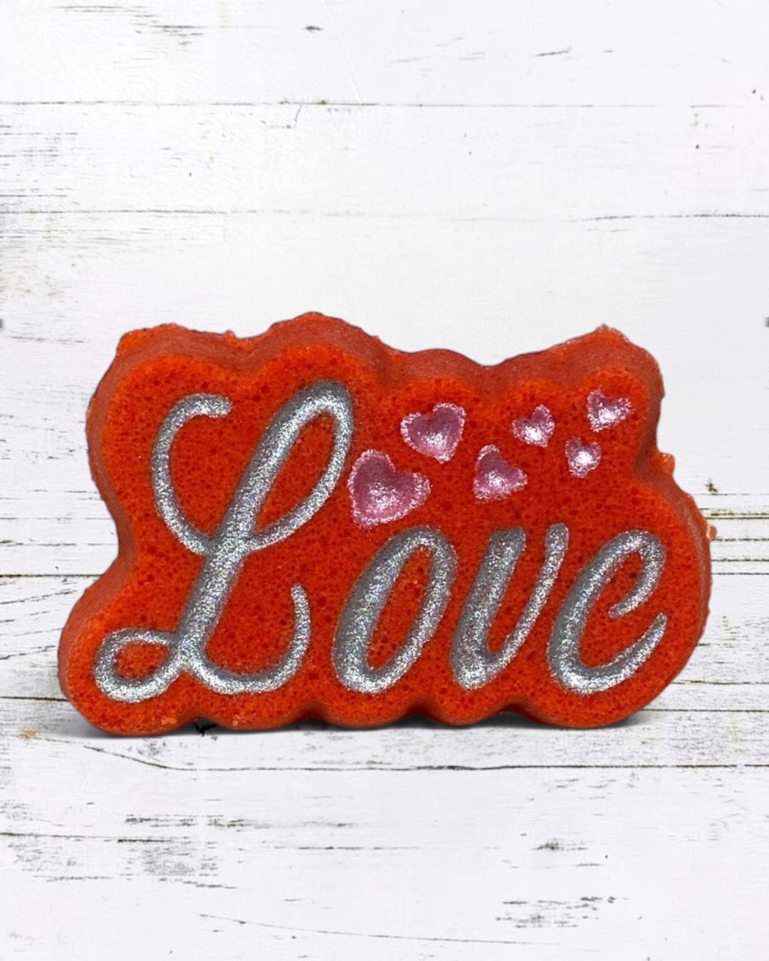 Calla Lily Cosmetics + CL kids red orange Love bath bomb with silver glitter lettering and pink heart accents