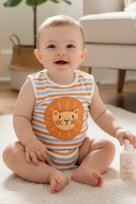 Calla Lily Cosmetics + CL kids organic cotton sleeveless baby romper with orange and blue stripes and a lion applique.