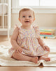 Calla Lily Cosmetics + CL kids organic cotton floral ruffle sleeve bodysuit for baby girls. Pink, yellow, and blue floral print.