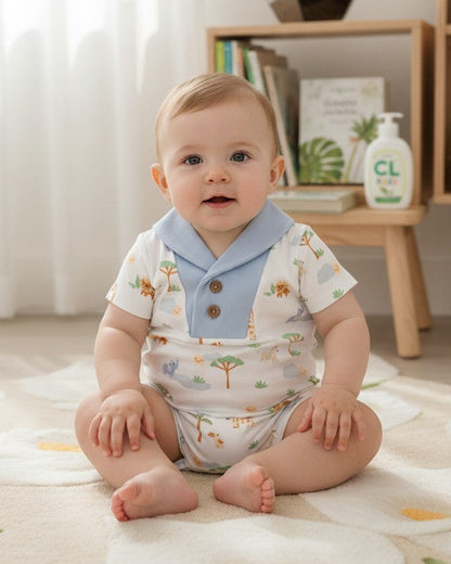 Calla Lily Cosmetics + CL kids white organic cotton baby romper with blue collar and safari print of lions, elephants, giraffes, zebras, and trees.