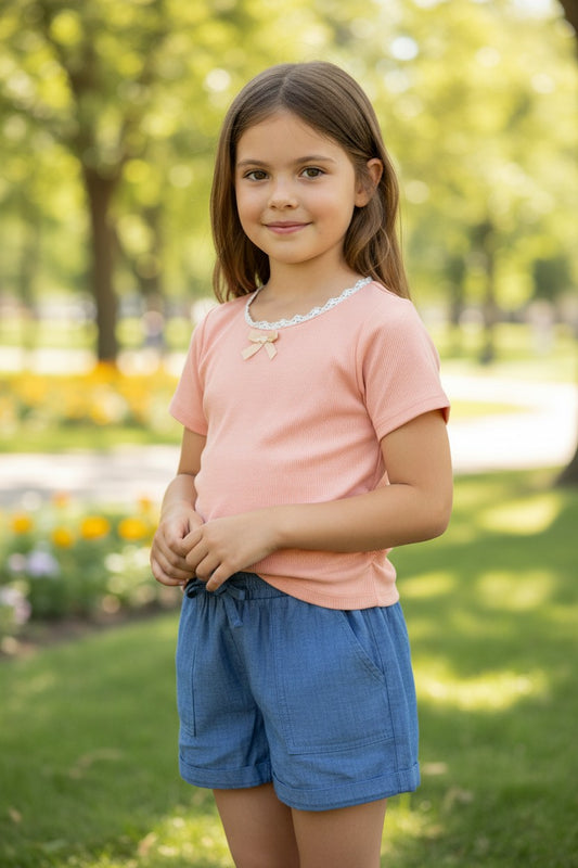 Calla Lily Cosmetics + CL kids toddler peach ribbed knit top with lace trim and bow, paired with blue chambray shorts.