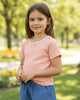 Calla Lily Cosmetics + CL kids toddler peach ribbed knit top with lace trim and bow, paired with blue chambray shorts.