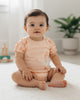Calla Lily Cosmetics + CL kids peach cotton bodysuit with seahorse and seashell print, short sleeves, snap closure.