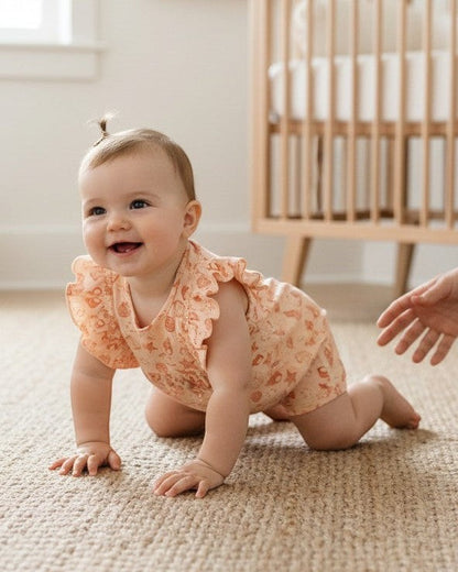 Calla Lily Cosmetics + CL kids peach cotton romper with seashell and starfish print, flutter sleeves, and snap closures.