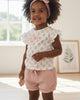 Calla Lily Cosmetics + CL kids white cotton t-shirt with pink floral print and ruffle sleeves, paired with pink gauze shorts. Includes headband.