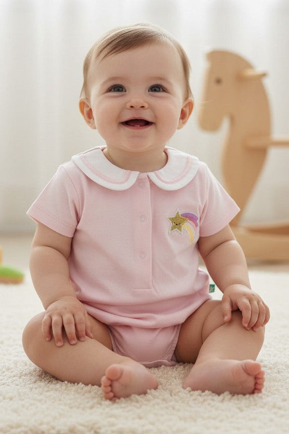 Calla Lily Cosmetics + CL kids pink organic cotton baby girls bodysuit with Peter Pan collar, shooting star embroidery, and snap closures.