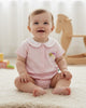 Calla Lily Cosmetics + CL kids pink organic cotton baby girls bodysuit with Peter Pan collar, shooting star embroidery, and snap closures.