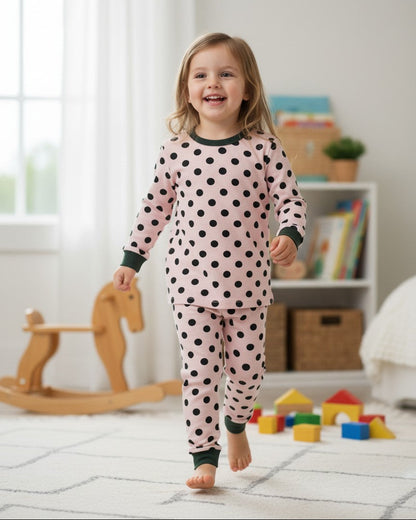 Calla Lily Cosmetics + CL kids pink thermal pajama set with black polka dots, long sleeves, and cuffed ankles. 60% Cotton 40% Polyester.