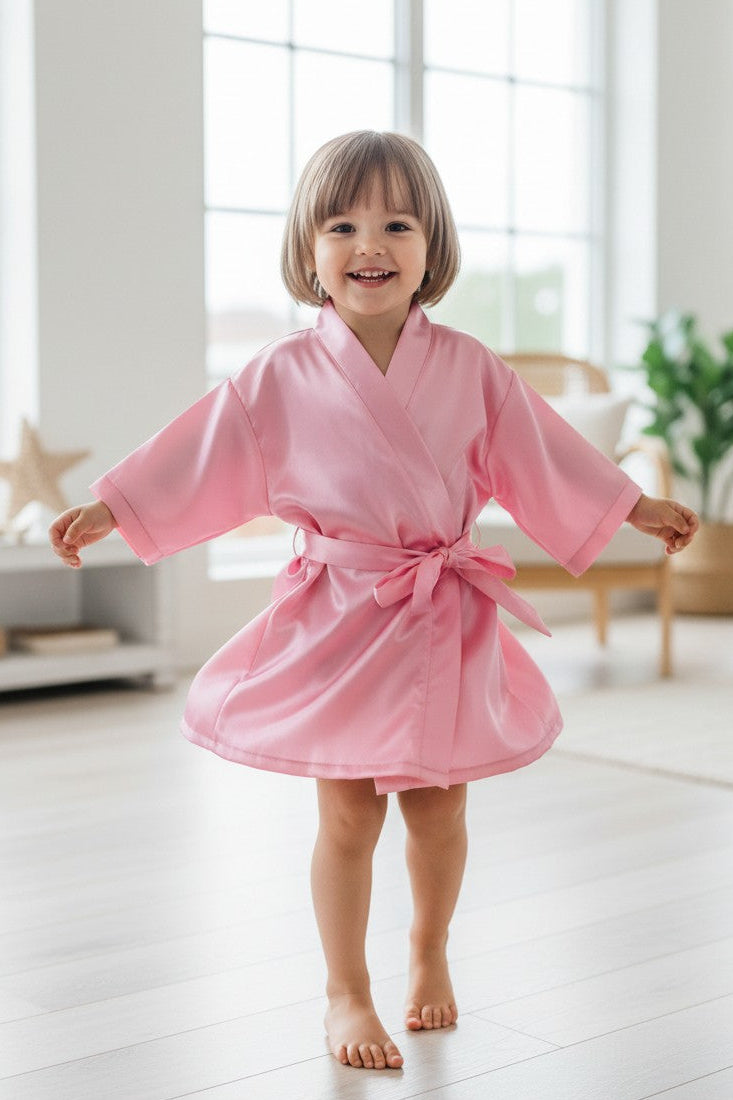 Calla Lily Cosmetics + CL kids pink satin toddler princess robe with tie waist and short sleeves.