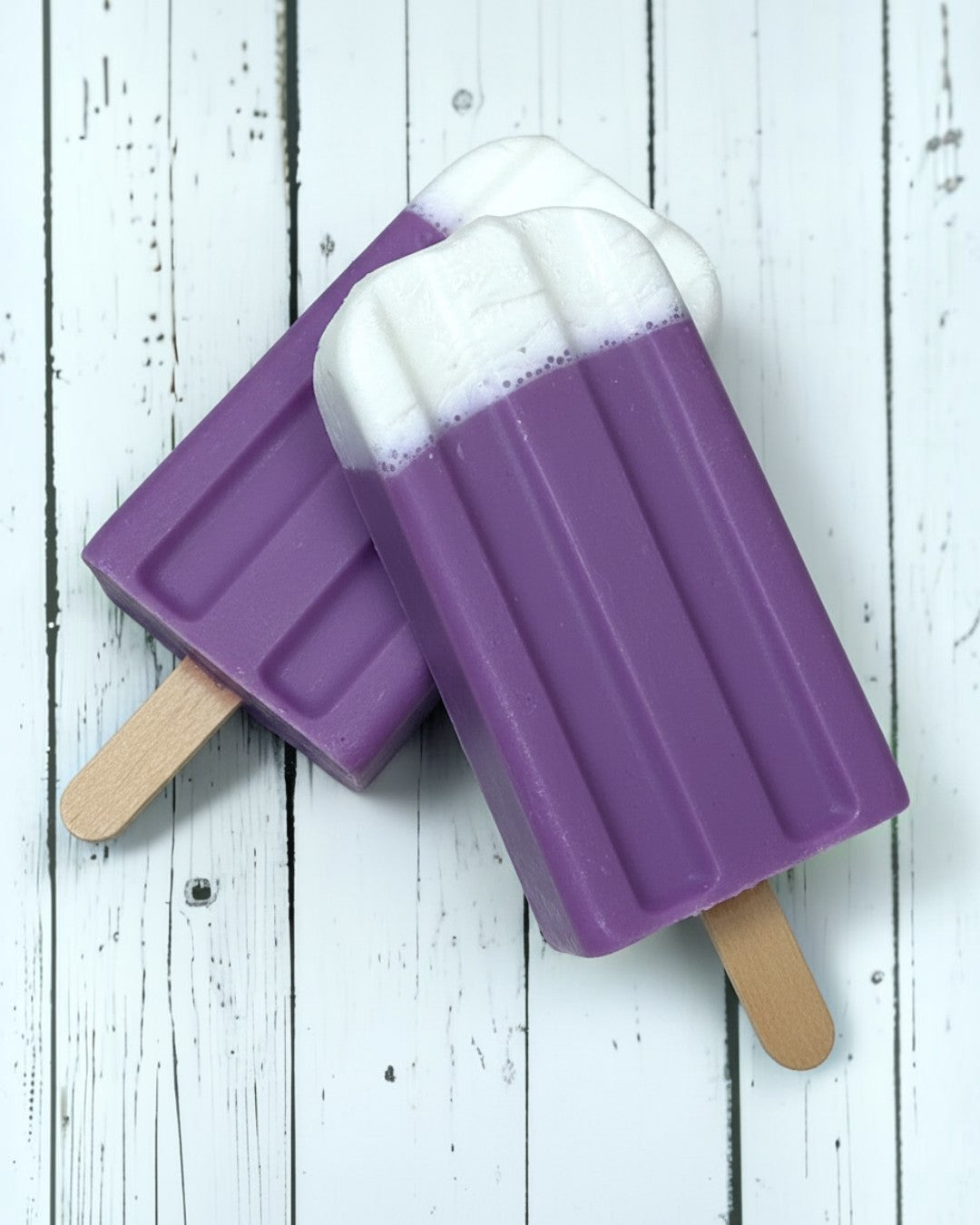 Calla Lily Cosmetics + CL kids purple and white shea butter popsicle soap on a rustic white wooden background.