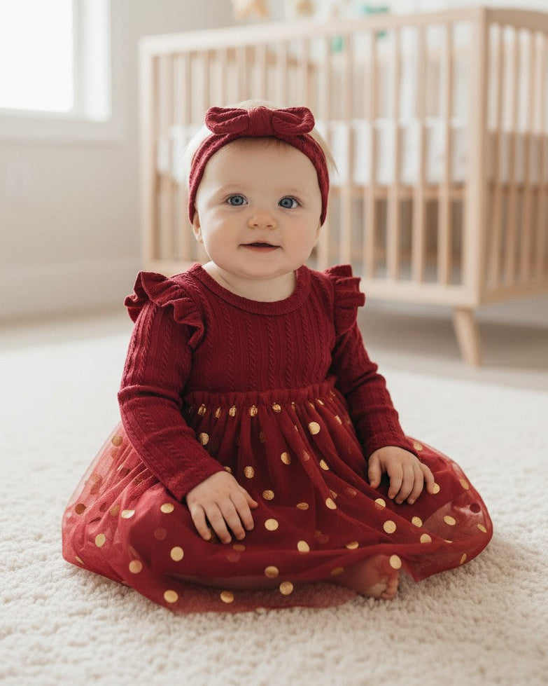 Calla Lily Cosmetics + CL kids red baby dress with gold polka dots and matching headband. Long sleeves, polyester-spandex blend.