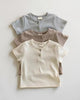 Calla Lily Cosmetics + CL kids three ribbed baby tees in blue, taupe, and cream with button details.
