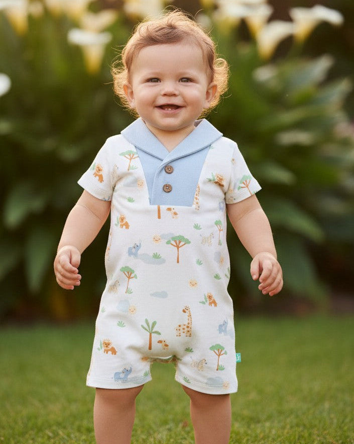 Calla Lily Cosmetics + CL kids white organic cotton baby romper with safari print, blue collar, and wooden buttons.
